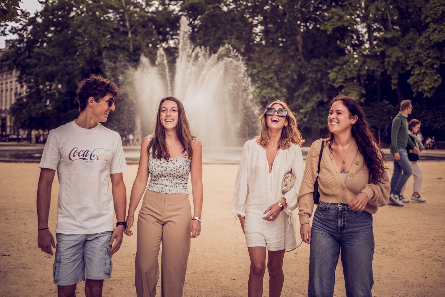 Friends walking near a fountain in Brussels, Belgium